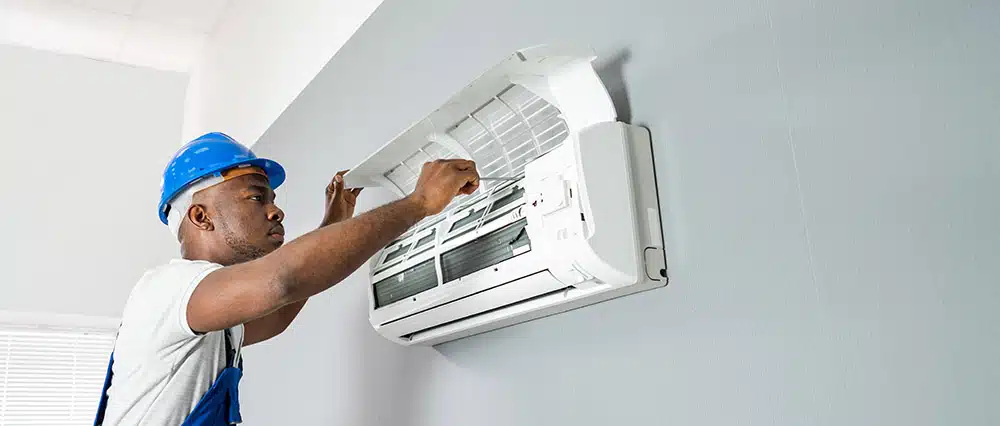 Technician tinkering with an AC