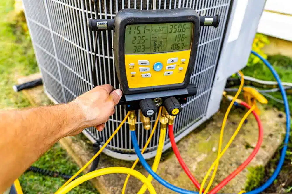 Technician tinkering with an AC