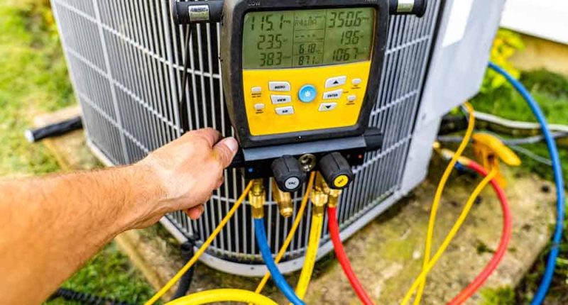 Technician tinkering with an AC